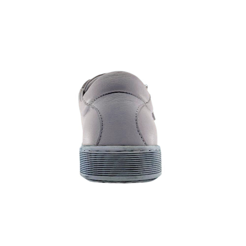 Cream sneaker with a textured sole on a white background
