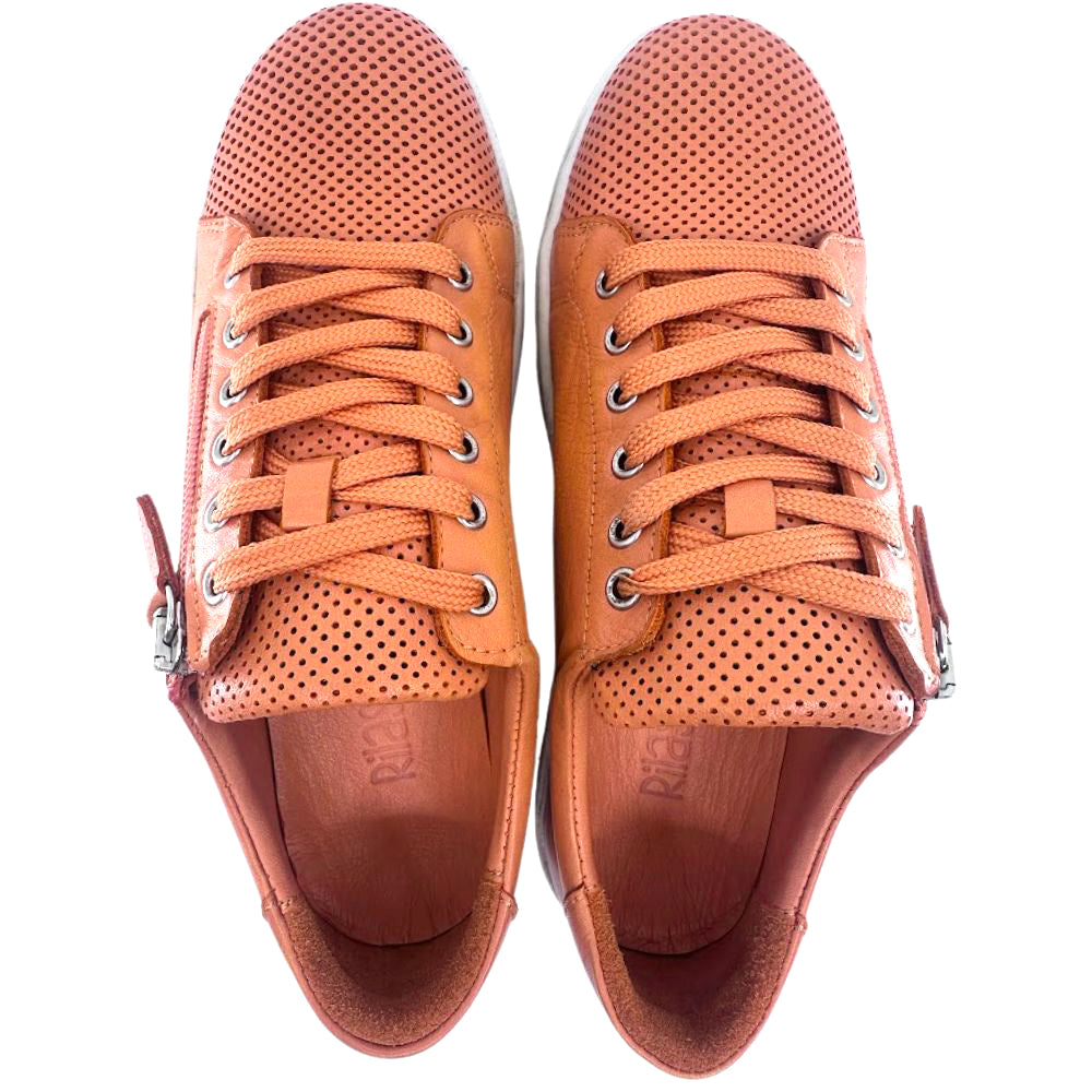 Pair of orange sneakers with perforated design on a white background