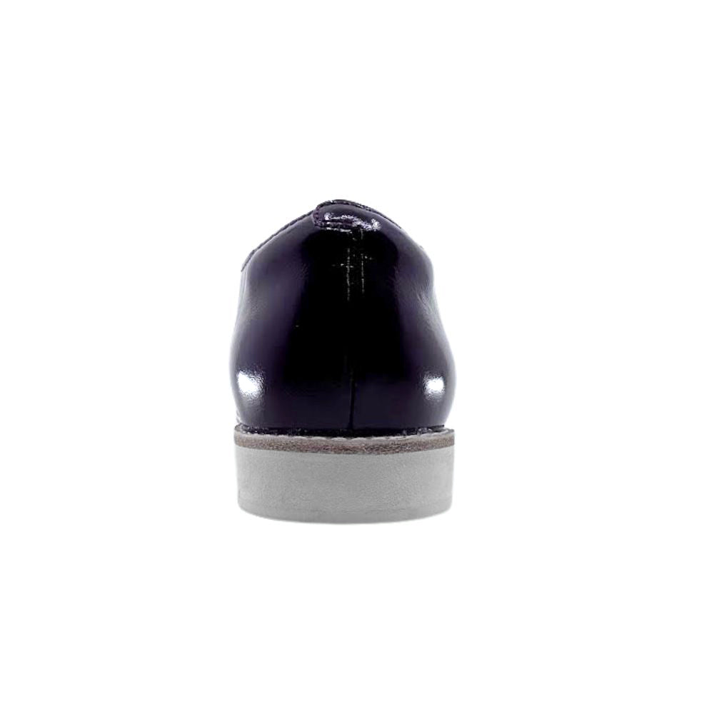 Back of cherry lace up shoe with a white sole on a white background