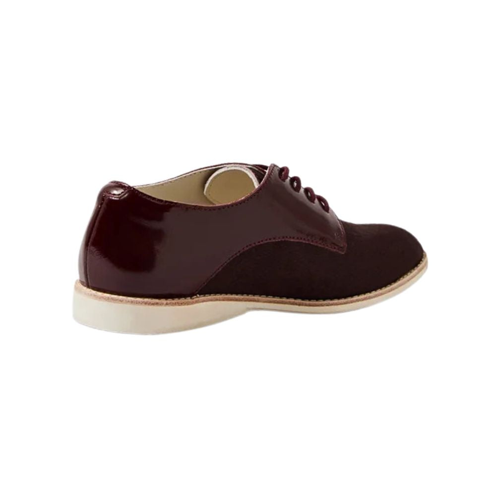 Cherry burgundy leather shoe with white sole on a white background