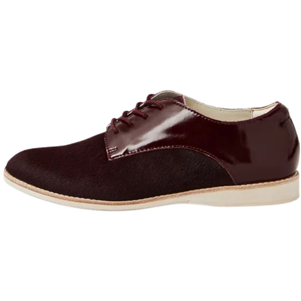 Cherry burgundy leather shoe with a white sole on a white background