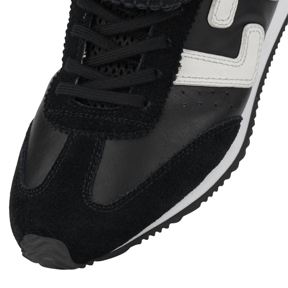 Black sneaker with white sole on a white background