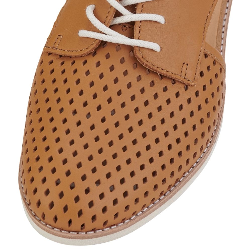 A close-up view of a tan leather lace-up shoe with a perforated leather toe cap, shown against a white background.