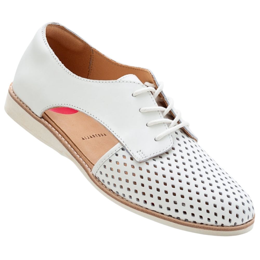 A white leather lace-up shoe with perforated detailing on the toe and cut-out side panels, a tan insole, and a white sole, shown on a plain white background.
