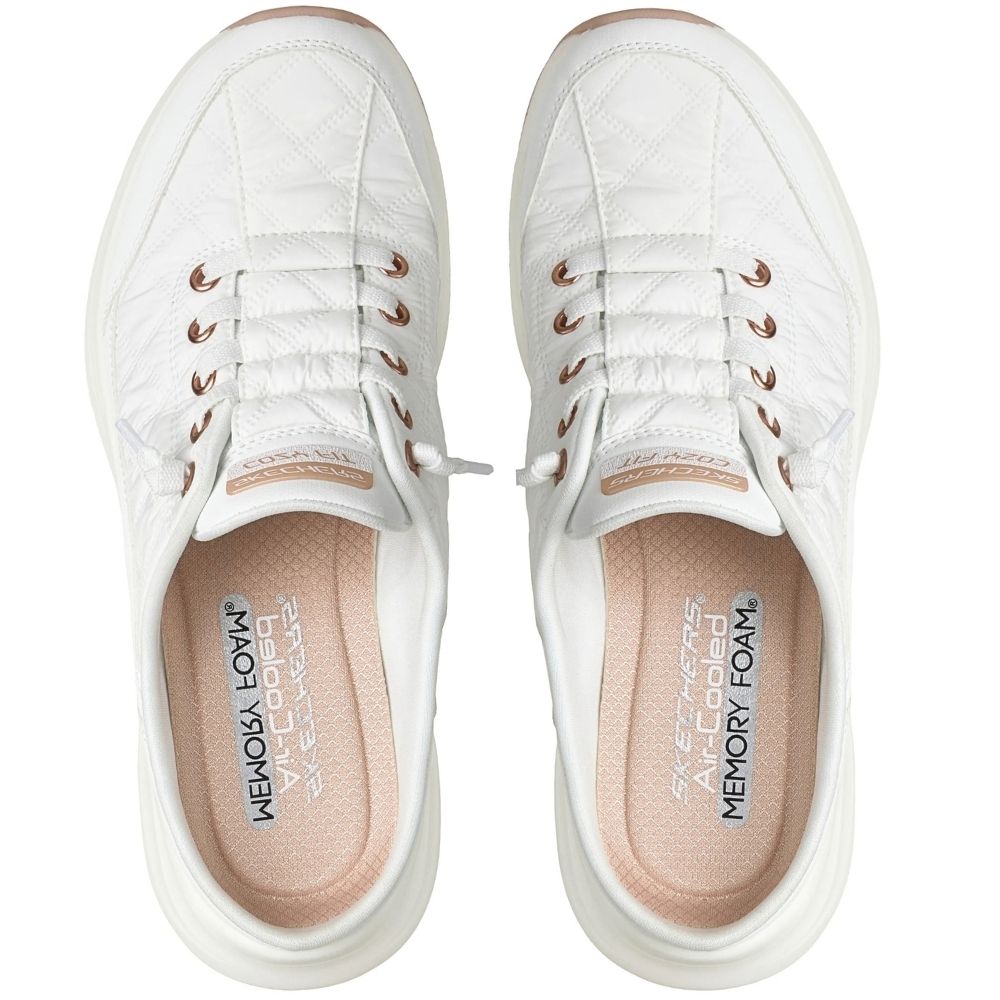 A pair of white slip-on mule sneakers by SKECHERS featuring rose gold metallic details, shown from a top-down perspective, against a white background.