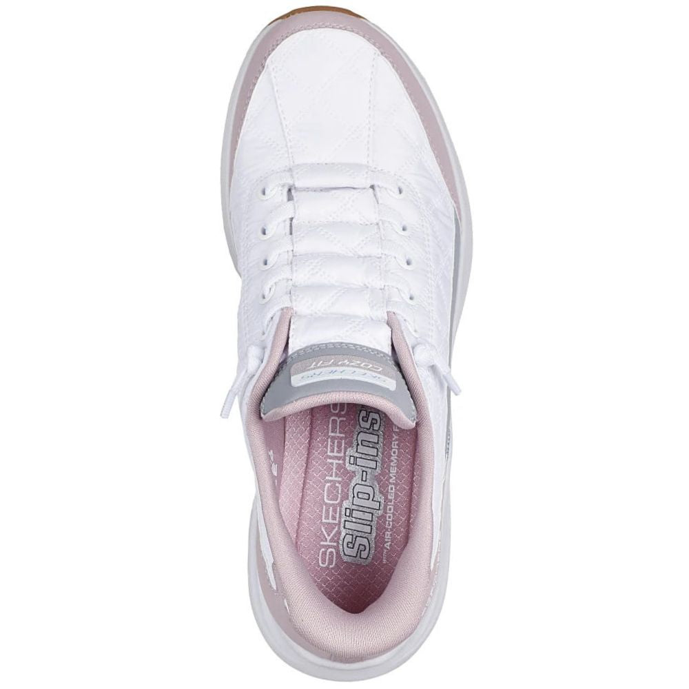A white Skechers slip-on sneaker shown from a top-down view, featuring a white upper, white laces, a light pink inner lining, and a gray tongue label.