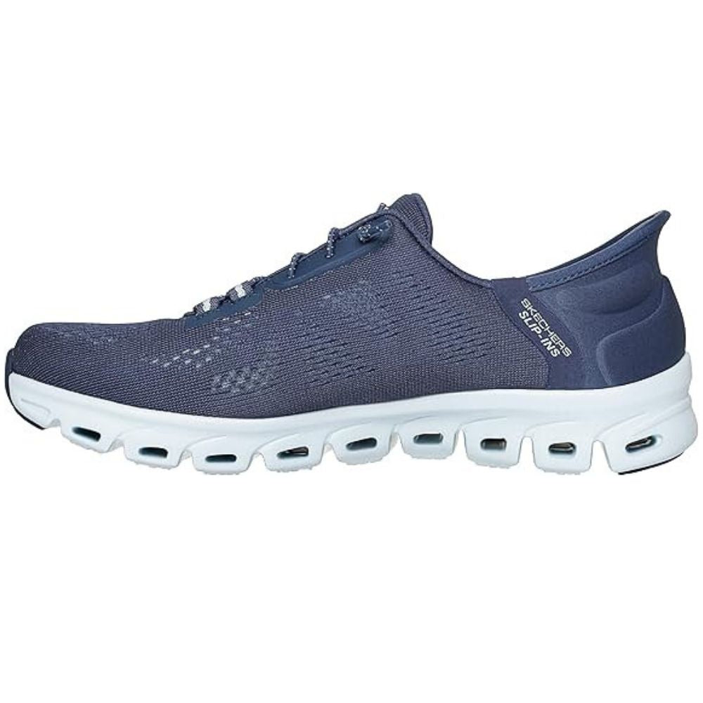 Navy shoe with flexible white sole with visible Skechers brand logo on a white background