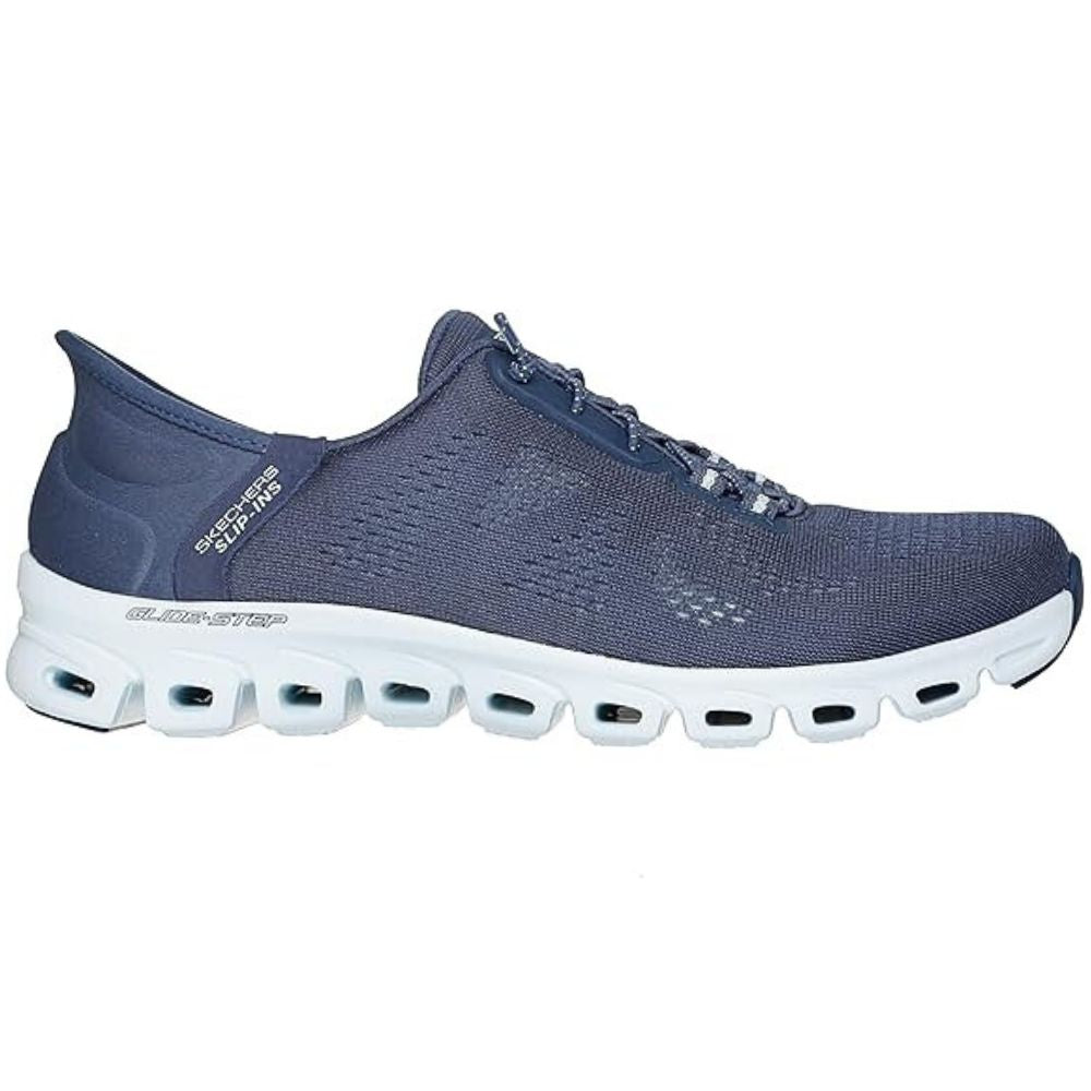 Navy shoe with flexible white sole with visible Skechers brand logo on a white background