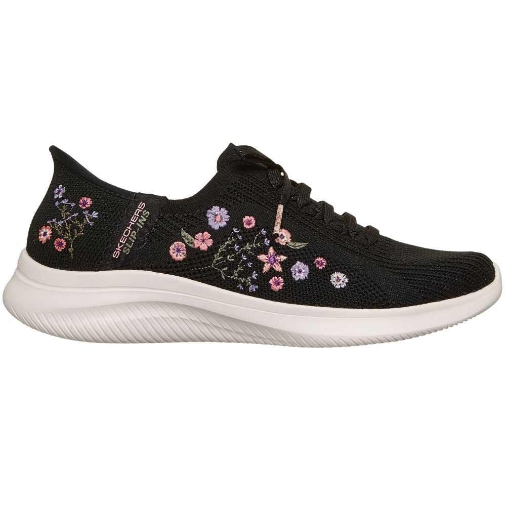 Black sneaker with floral embroidery on a white background