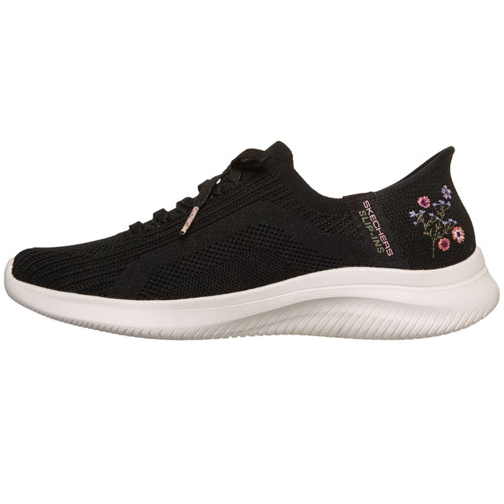 Black sneaker with floral design on a white background