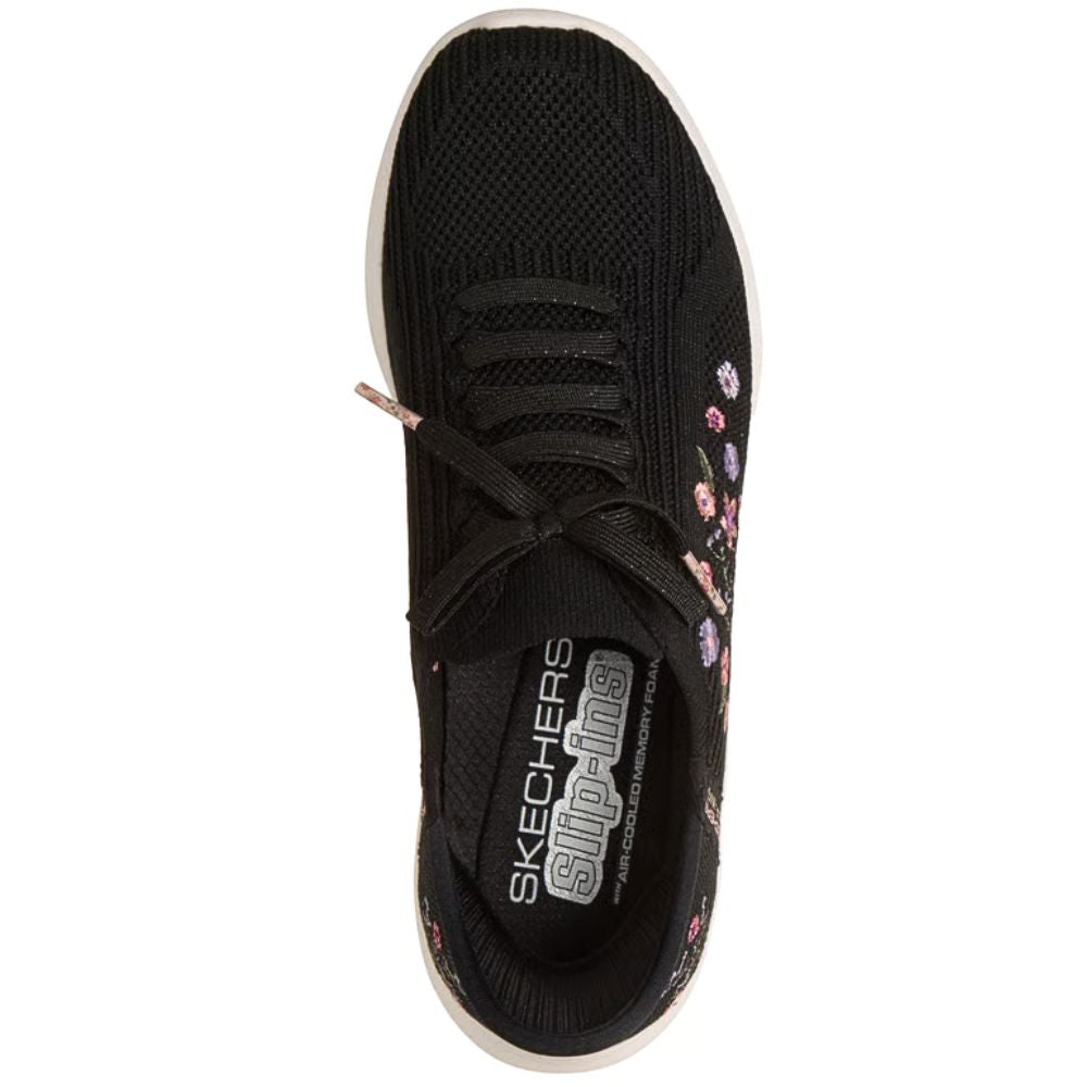 Black sneaker with floral design on a white background
