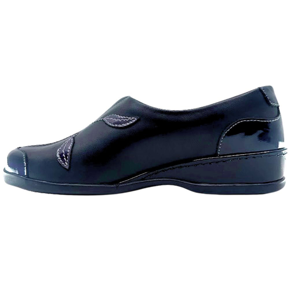 Black slip on shoe on a white background