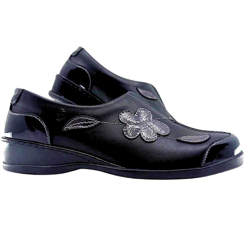 Black shoe with floral design on a white background