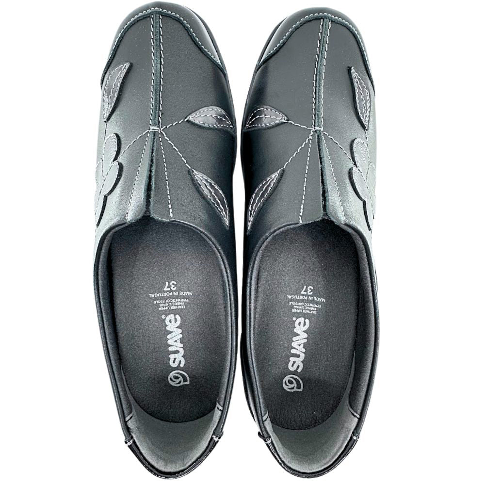 Pair of black slip-on shoes with floral designs on a white background