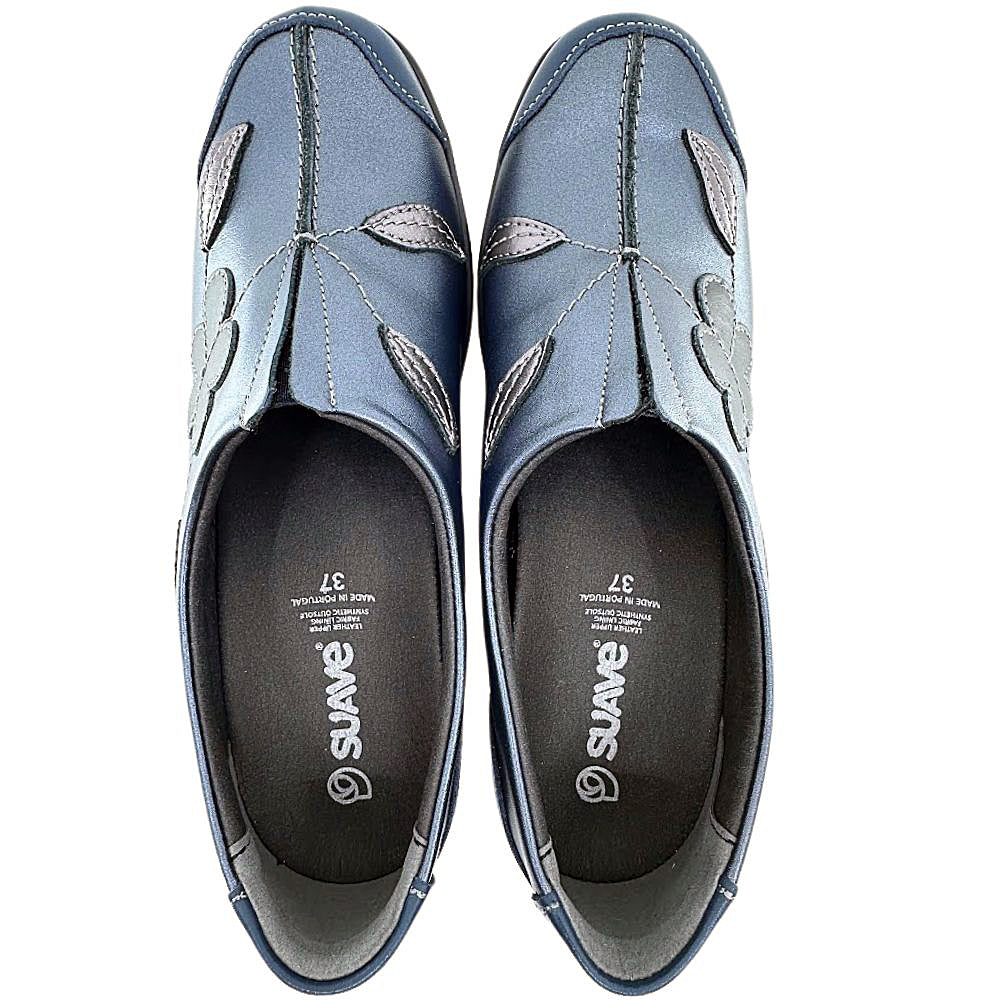 Pair of blue slip-on shoes with floral patterns on a white background