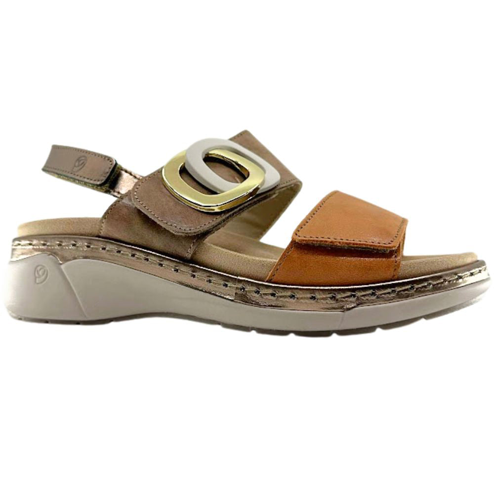 A women's wedge sandal in brown and tan leather with a large gold and silver buckle detail, shown from a side profile on a white background.