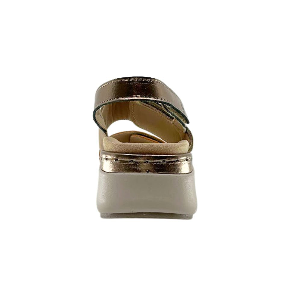 A single women's platform sandal shown from the back, featuring a metallic bronze strap and a thick taupe platform sole.