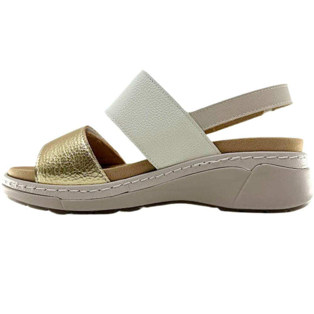 A women's platform wedge sandal featuring a textured metallic gold toe strap and a wide off-white ankle strap, set on a beige platform sole with white contrast stitching.