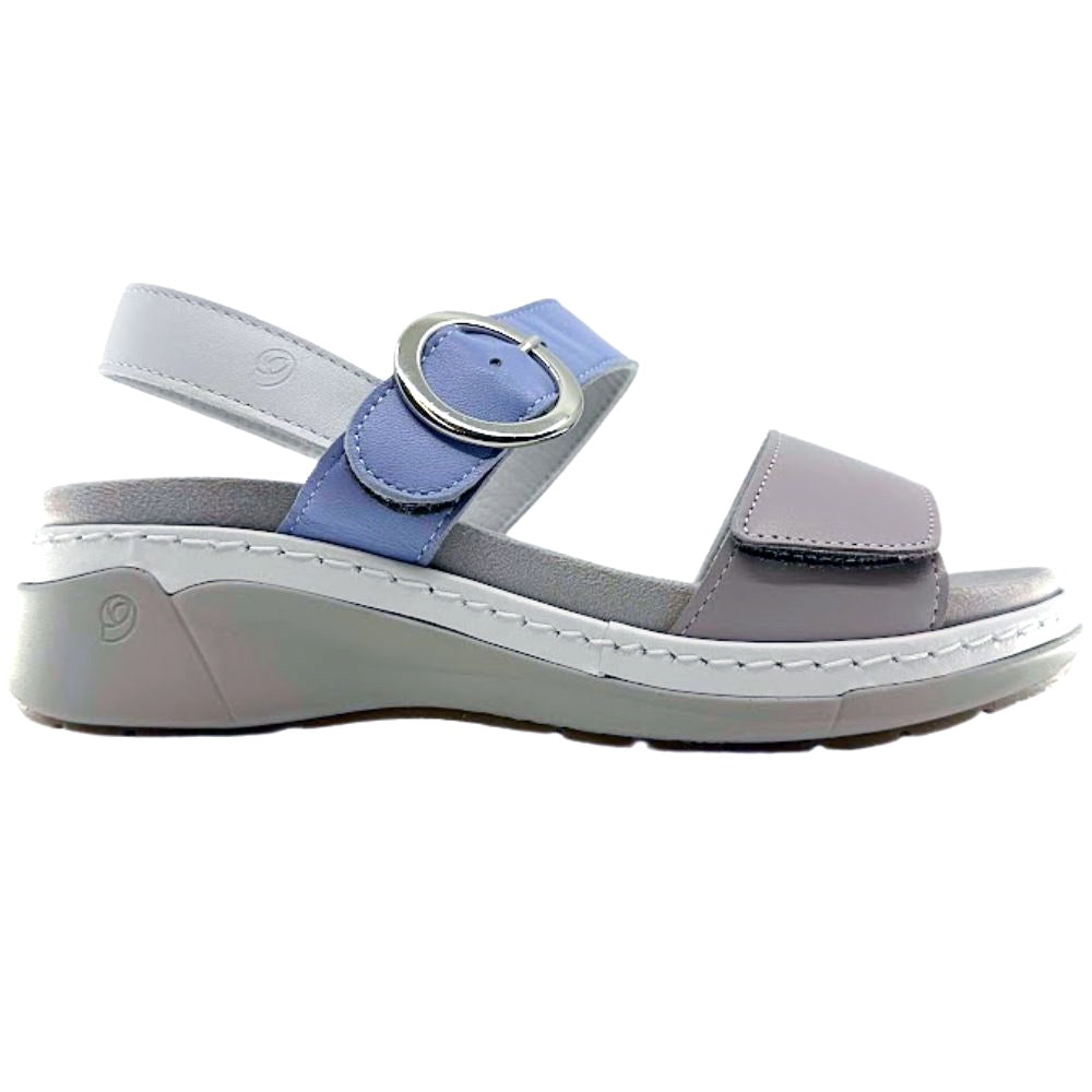 A women's platform wedge sandal in light gray and dusty blue, featuring a wide adjustable strap with a silver-tone circular buckle, a wide toe strap, and a thick gray platform sole.
