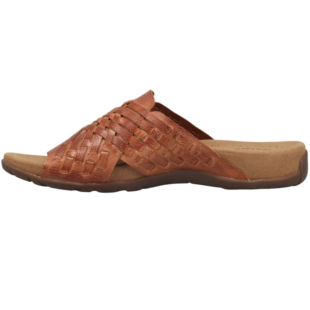 A single tan woven leather slide sandal with a contoured sole, shown in a side profile view against a plain white background.