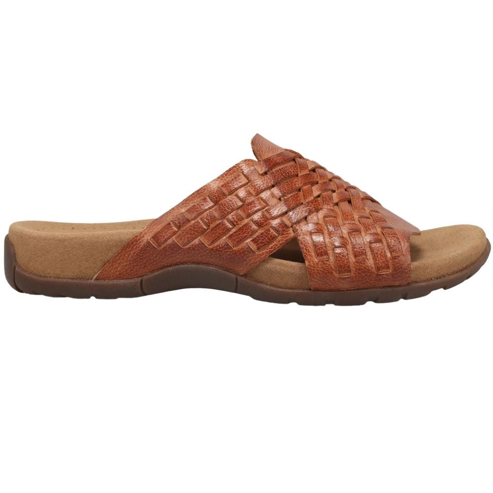 A single tan woven leather slide sandal with a contoured footbed and dark brown sole, shown in a side profile view against a plain white background.