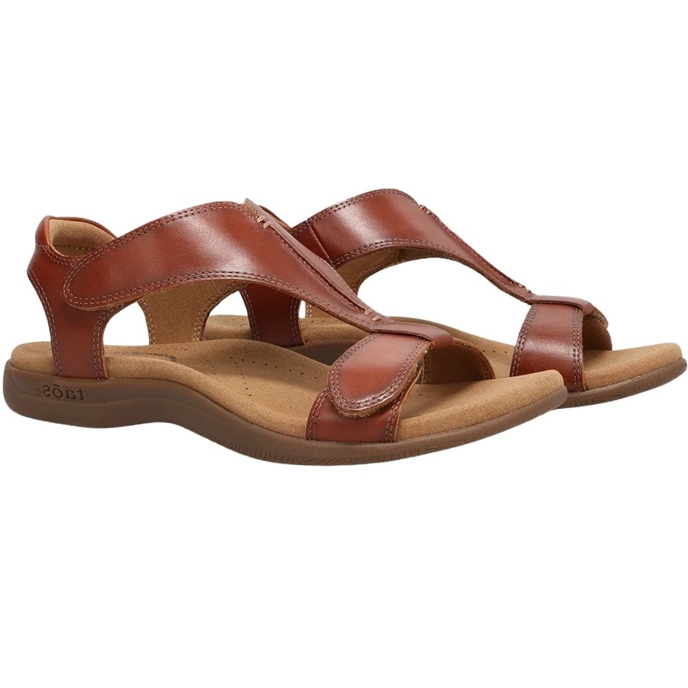 A pair of women's cognac leather strappy sandals with a contoured wedge sole, shown from a side profile view on a white background.