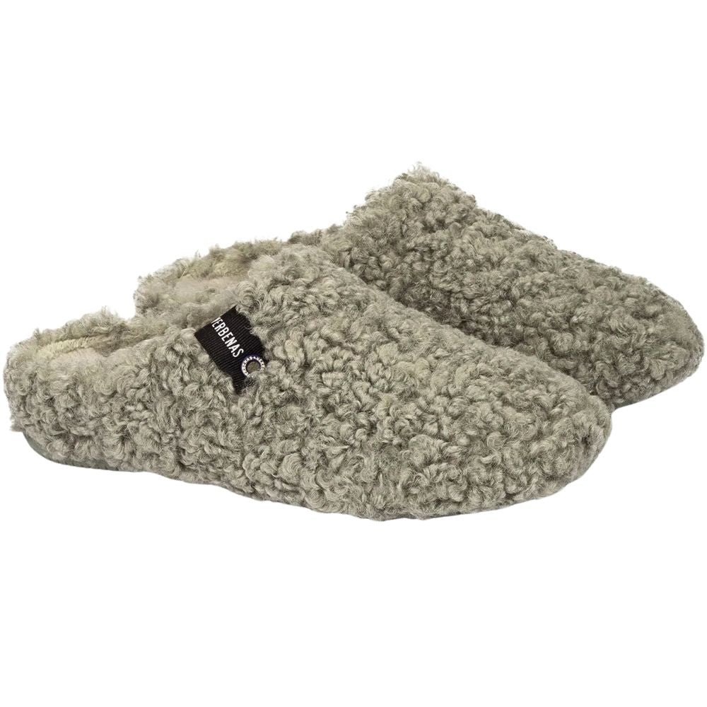 Pair of green textured slippers on a white background