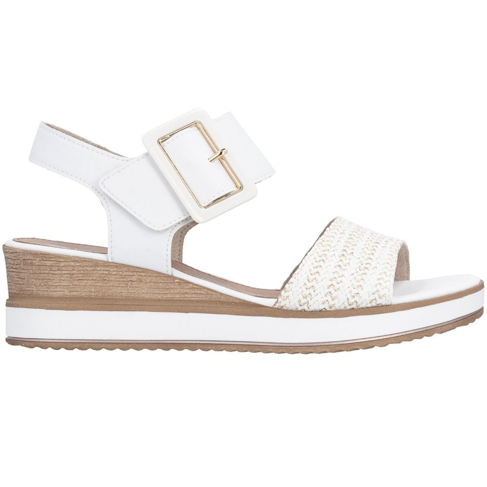 A white wedge sandal with a woven textured toe strap, a white ankle strap with a gold-tone buckle, and a brown wood-look wedge heel, shown from a side profile on a white background.