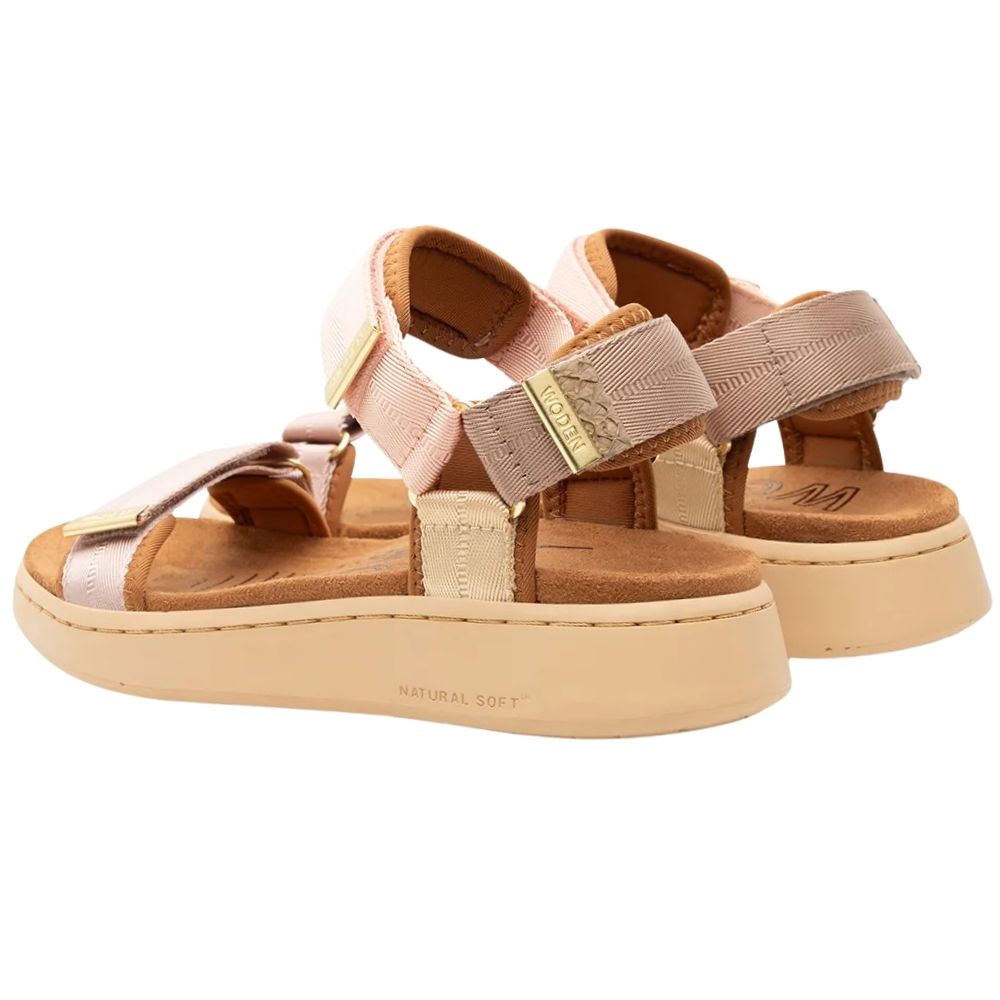 A pair of women's platform sandals in a soft blush pink and beige colorway, featuring adjustable straps with gold-tone metal buckles and a thick beige sole.