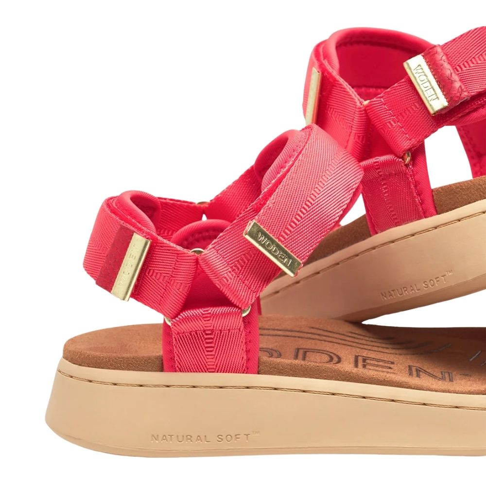 A pair of red woven-strap sandals with gold-tone hardware and beige soles, photographed on a clean white background.