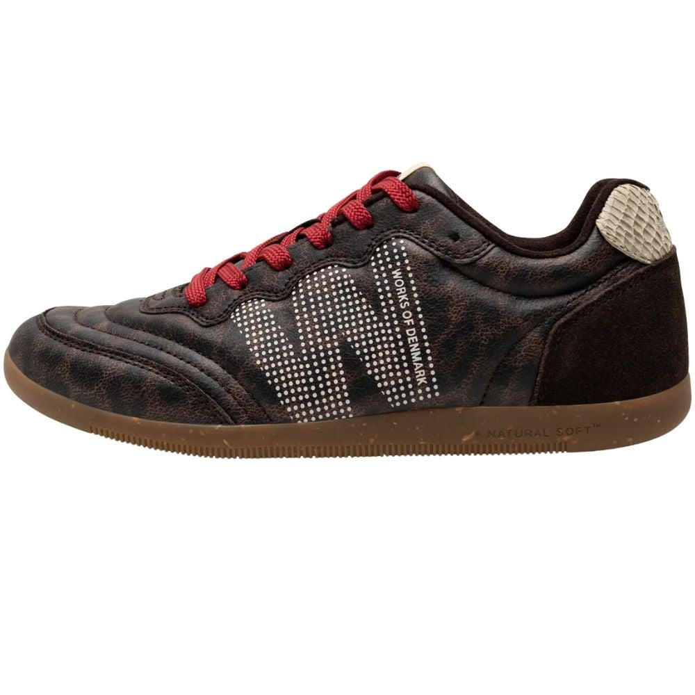 A low-top sneaker by Woden featuring a dark brown textured animal print upper, red laces, and a brown gum rubber sole.