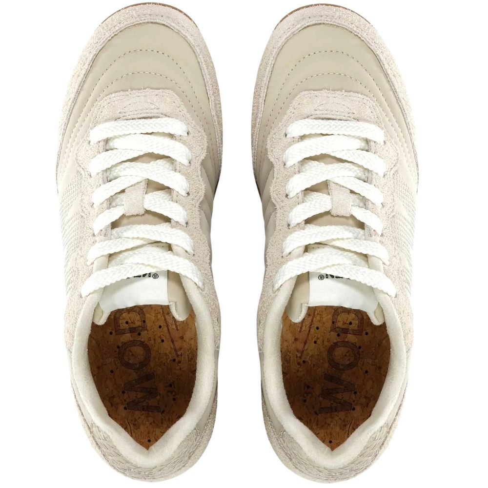 A pair of low-top sneakers shown from a top-down view, featuring off-white textured recycled uppers, white laces, and a brown cork-like insole with the brand name 'WODEN' printed on the inside.
