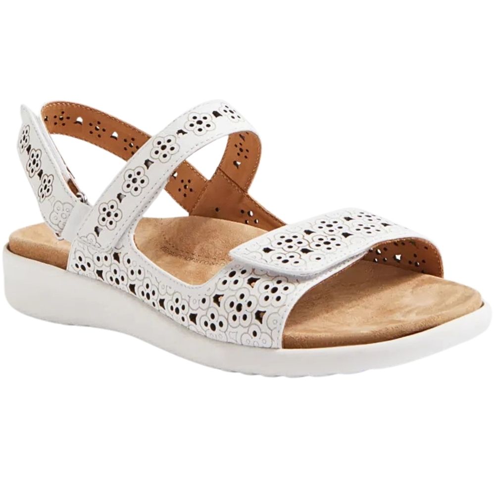 A white open-toe wedge sandal with laser-cutout straps and a tan footbed, shown from a side angle on a white background.