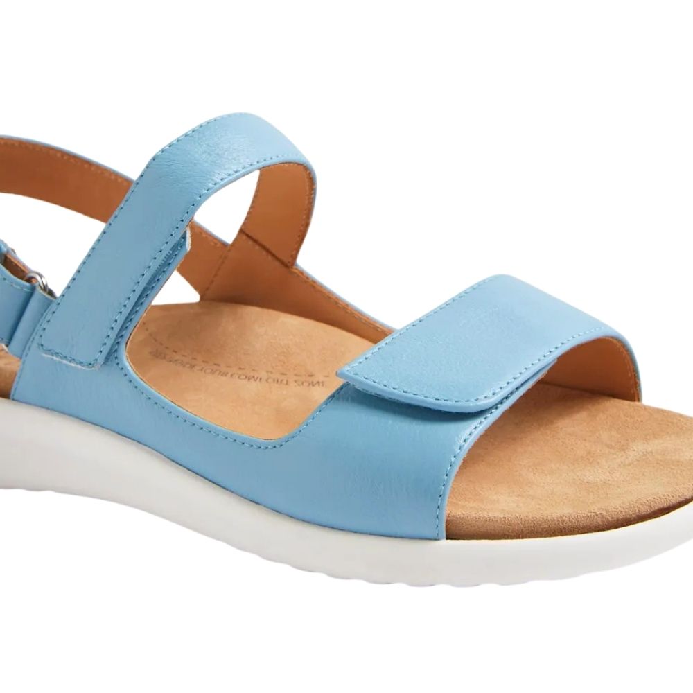 A light blue leather ZIERA sandal with three Velcro strap closures, a tan anatomic microfibre footbed, and a white sole, shown against a plain white background.
