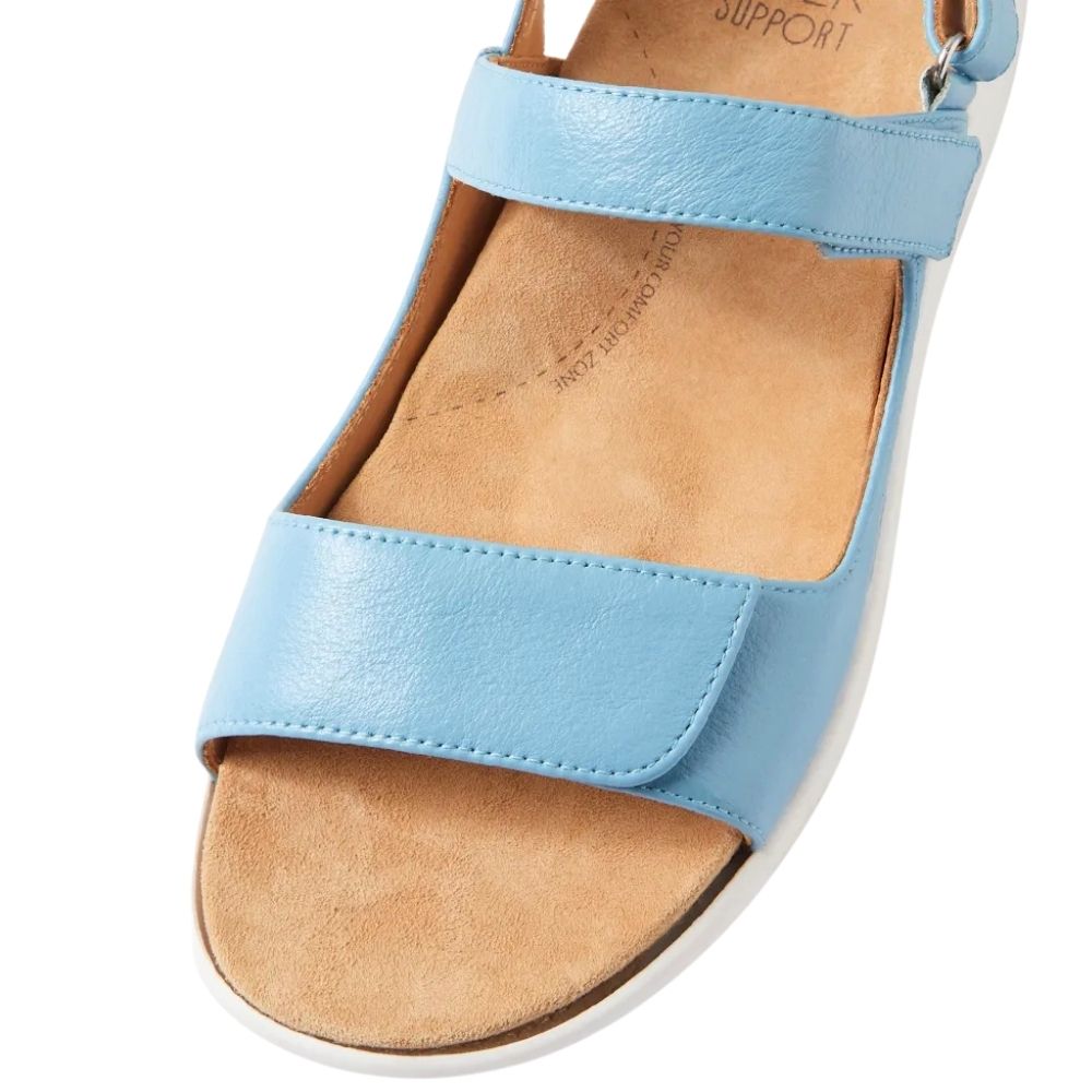 A light blue leather ZIERA sandal with a tan anatomic, microfibre footbed and a white sole, shown from a high-angle view on a white background.