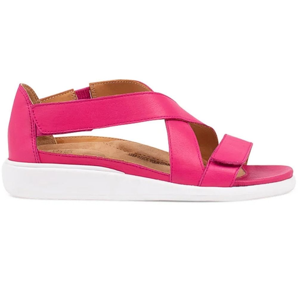 A bright pink platform sandal with crisscrossing straps and a white sole, shown in a side profile on a white background.