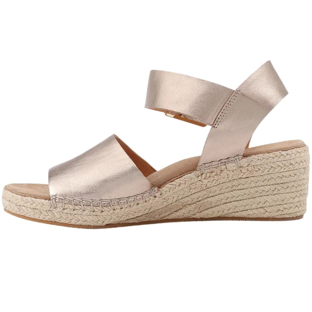 A single women's espadrille wedge sandal in a metallic champagne color, featuring a braided jute wedge midsole, shown from a side profile on a white background.