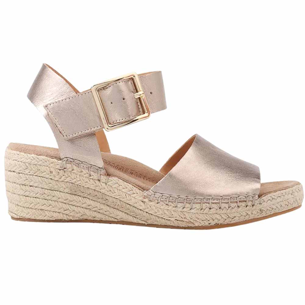 A metallic leather espadrille wedge with an open toe and ankle strap adorned with a gold buckle, against a white background.