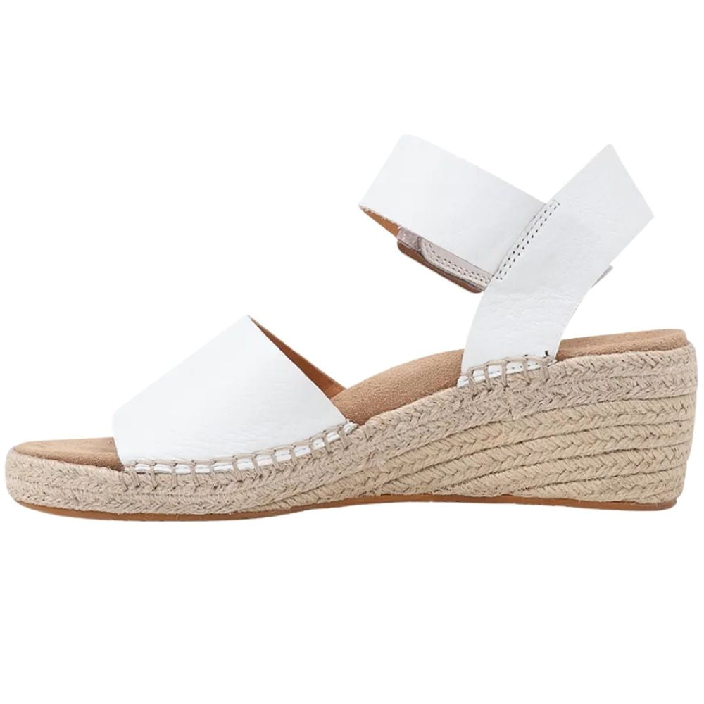 A white leather wedge espadrille sandal with an ankle strap and a braided jute wedge heel, shown in a side profile on a white background.