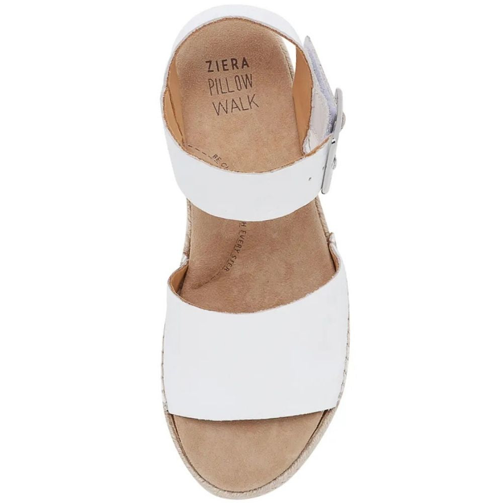 The top of a white leather wedge espadrille sandal with a silver buckle ankle strap and a tan insole with 'Ziera Pillow Walk', shown against a white background.